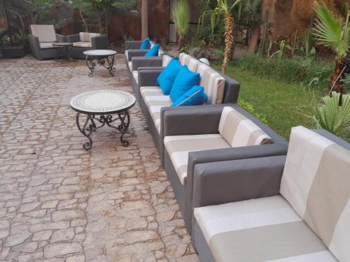 a row of couches and tables on a patio at Imperial Holiday Hôtel & spa in Marrakech
