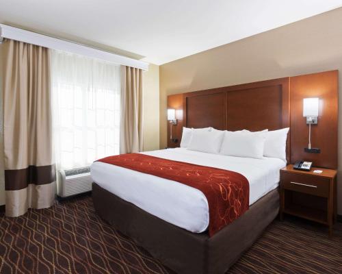 a hotel room with a large bed and a window at Comfort Suites DuBois Country Club in DuBois