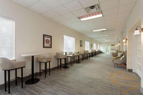 a waiting room with a row of chairs and tables at Wyndham Garden Tallahassee Capitol Near FSU in Tallahassee