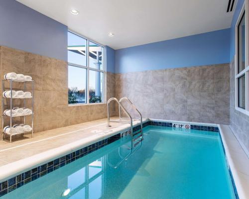 a bathroom with a swimming pool with a window at Comfort Suites DuBois Country Club in DuBois
