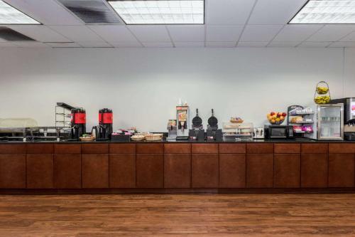 a kitchen with a counter with food on it at Wyndham Garden Tallahassee Capitol Near FSU in Tallahassee