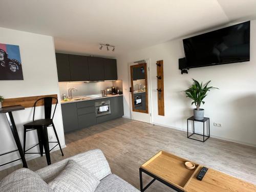 a living room with a couch and a table at MEINpartments Wolfsburg in Wolfsburg
