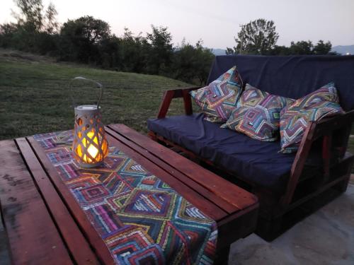a blue couch and a table with a lamp on it at Kuća za odmor Filipović in Gornji Milanovac