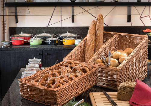 two baskets of bread on a table in a kitchen at Ramada by Wyndham München Airport in Oberding