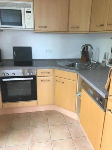 a kitchen with a sink and a stove top oven at Apartment "Suites" Biermann in Garding