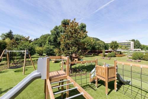a playground with a swing set and a slide at Sheraton Lake Como Hotel in Como