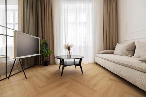 a living room with a couch and a table at GENeve - old town apartment Bratislava in Bratislava