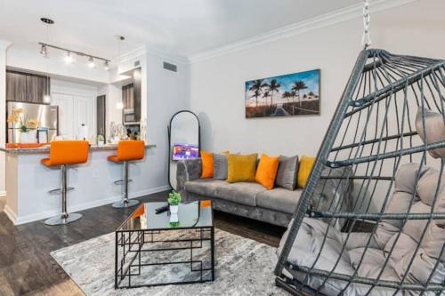 a living room with a gray couch and orange chairs at NRG Stadium, the Medical Center Bright and Cozy Unit in Houston