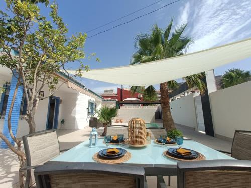 a table with plates of food on a patio at Stunning Villa in Aguadulce, Almería Private Pool 400 sqm area 800m Beach in Aguadulce