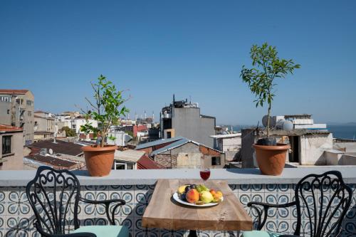 a plate of fruit on a table on a balcony at Valeria Antique 1892 in Istanbul