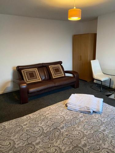 a living room with a couch and a bed at 2 Bedroom Flat with free parking in Manchester in Manchester
