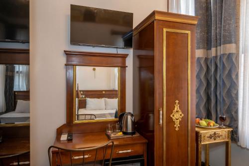 a room with a mirror and a wooden cabinet at Valeria Antique 1892 in Istanbul