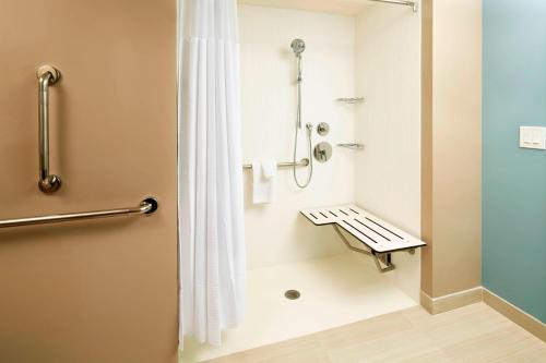 a bathroom with a shower with a shower curtain at Courtyard by Marriott Orlando Lake Nona in Orlando