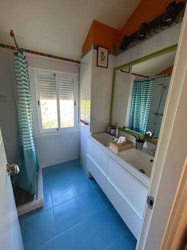 a bathroom with a tub and a sink and a mirror at Casa Rural Cupiana Piscina privada Malaga in Málaga