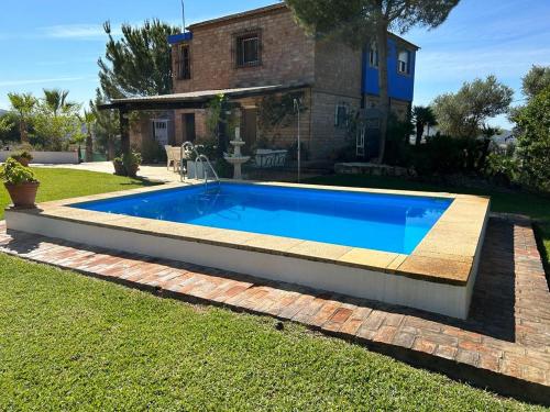 una piscina nel cortile di una casa di Casa Rural Cupiana Piscina privada Malaga a Málaga