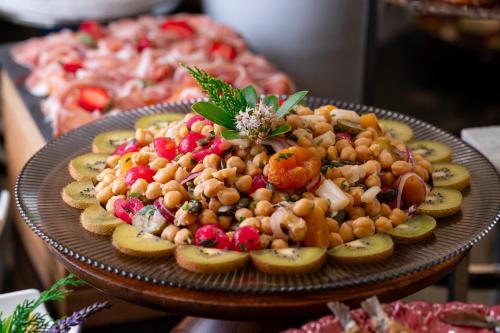 a plate of food with fruit on a table at InterContinental Porto - Palacio das Cardosas by IHG in Porto