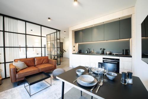 a kitchen and living room with a table and a couch at Mono Design Apartments in Stuttgart