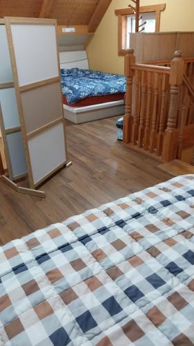 a room with a checkered floor and a bed at White House in Namhae