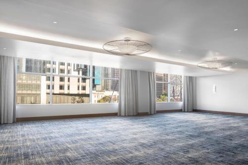 a large room with large windows and white walls at The Ritz-Carlton, Los Angeles L.A. Live in Los Angeles
