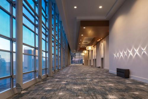 an empty hallway in a building with large windows at The Ritz-Carlton, Los Angeles L.A. Live in Los Angeles