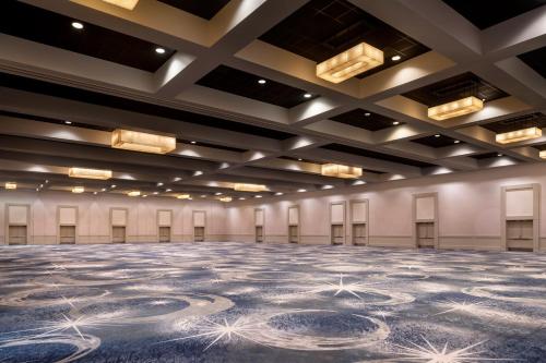 an empty ballroom with a large carpeted floor in a building at The Ritz-Carlton, Los Angeles L.A. Live in Los Angeles