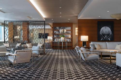 a lobby of a hotel with couches and chairs at The Ritz-Carlton, Los Angeles L.A. Live in Los Angeles