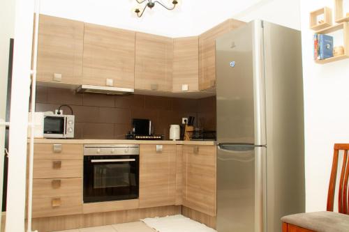 a kitchen with a stainless steel refrigerator at AQA - No4, 360 degrees photos of the apartment to know exactly what you are booking in Athens