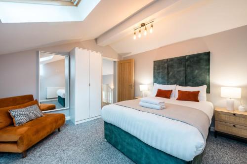 a bedroom with a large bed and a chair at Host & Stay - The Georgian Coach House 2 in Liverpool