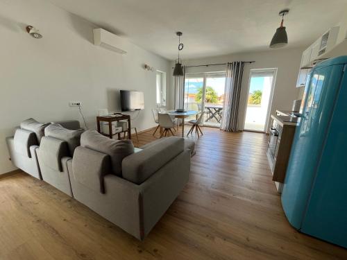 a living room with a couch and a table at Seaview Apartment Villa Sia in Vantačići