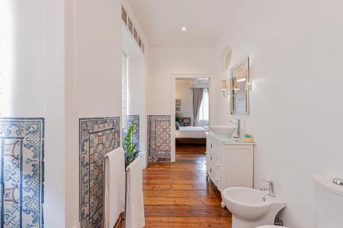 a bathroom with a toilet and a sink at Palacio Ramalhete in Lisbon