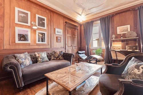 a living room with a couch and a table at Palacio Ramalhete in Lisbon