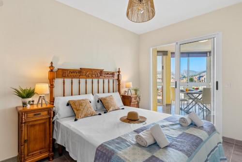 a bedroom with a large bed and a balcony at Apartamento Bondi - PlusHolidays in Calpe