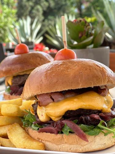 two sandwiches and french fries on a plate at Eurohotel Swarzędz in Swarzędz