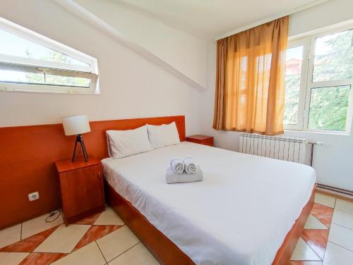 a bedroom with a bed with two towels on it at Villa D&L in Ohrid