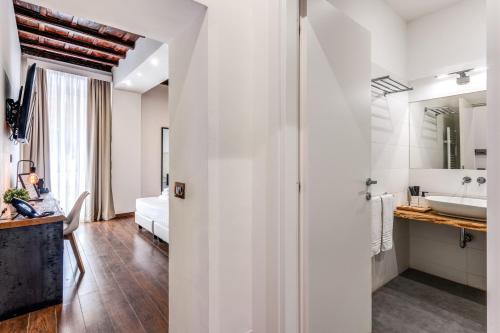 a white bathroom with a sink and a tub at Effe Luxury Palace in Rome