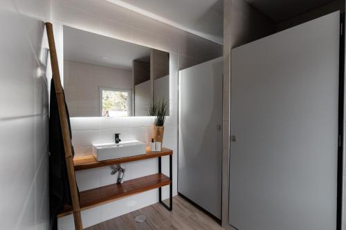 a bathroom with a sink and a mirror at Eco Surflodge Azores in Ribeira Grande