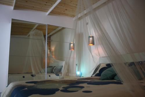 a bedroom with a bed with a canopy at Blue B&B in Formia