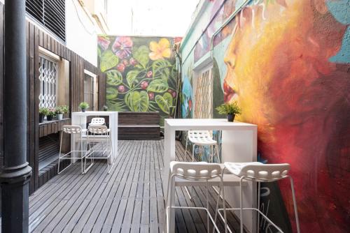 a room with a mural of a face on the wall at No Limit Barcelona Central in Barcelona