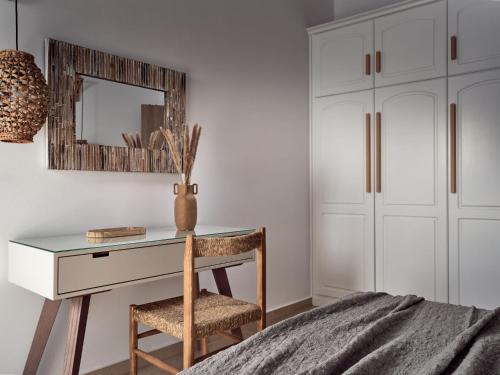 a bedroom with a desk with a chair and a mirror at La Maison Du Maire - Luxury Villa with Private Pool, by ZanteWize in Sarakinádhon