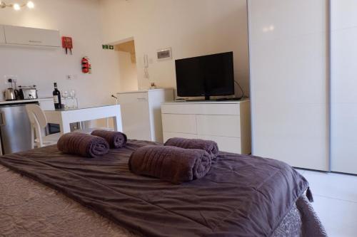 a bedroom with a bed with pillows on it at SPQR Studios 2 Valletta in Valletta