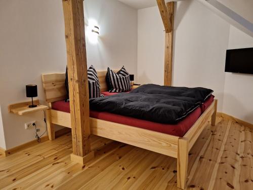 a bedroom with a bed with a wooden frame at Dammann's Hof in Bispingen