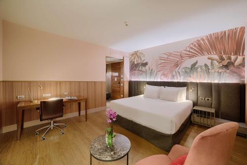 a hotel room with a bed and a desk at NH Collection Milano Touring in Milan