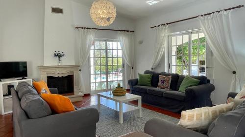a living room with two couches and a tv at Poço by Check-in Portugal in Albufeira