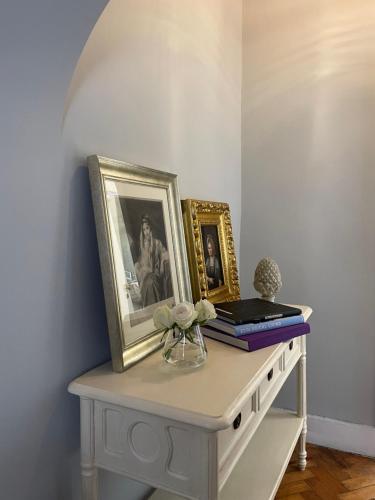 a table with some pictures and books on it at Palacio Ramalhete in Lisbon