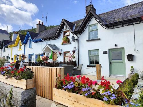 a white house with flowers in front of it at No. 173 'Widow's Row' in Newcastle