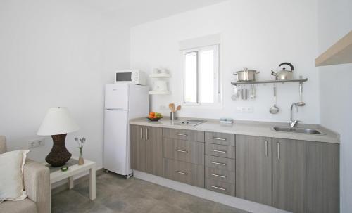 a kitchen with a sink and a refrigerator at Casas Karen in Los Caños de Meca