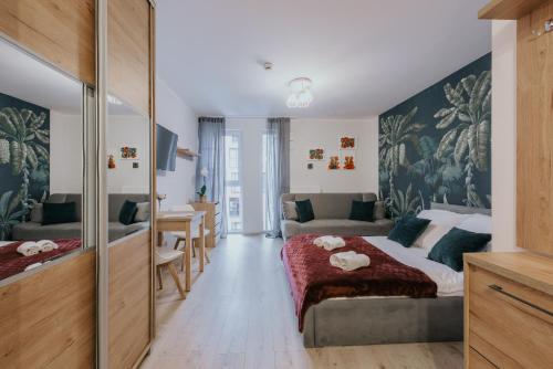 a bedroom with a bed and a living room at Mikro Aparty bezpłatny parking in Wrocław