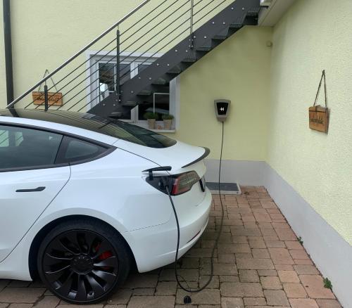 a white car parked in front of a building at Lieblingsplatz in Altenstadt