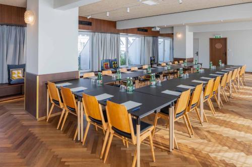 a large conference room with a long table and chairs at magdas HOTEL Vienna City - First Social Business HOTEL in Austria in Vienna