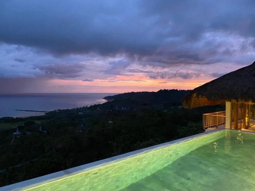 a view of the ocean from a villa with a swimming pool at Umarato Villa Sumba in Rua
